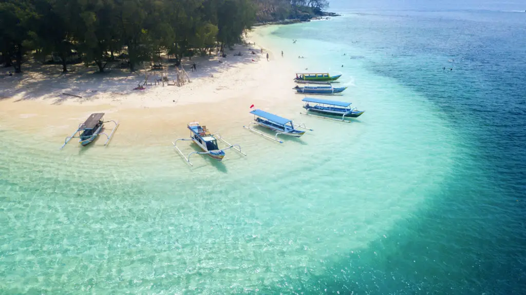 Bali - Indonesia. Aerial view of wooden boats anchored on the Gili Rengit beach in Lombok, Indonesia